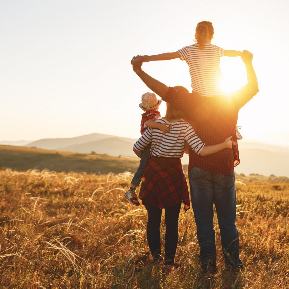 Happy family: mother, father, children son and  daughter on nature  on sunset